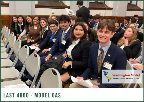 Smiling students in blazers and ties sit in rows at Washington Model OAS, looking forward.